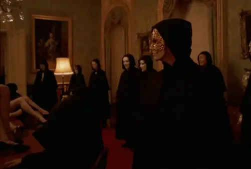 A pleasure-seeking man leaving a room where he witnessed a mind-blowing sexual show performed at the table - Eyes Wide Shut Orgy
