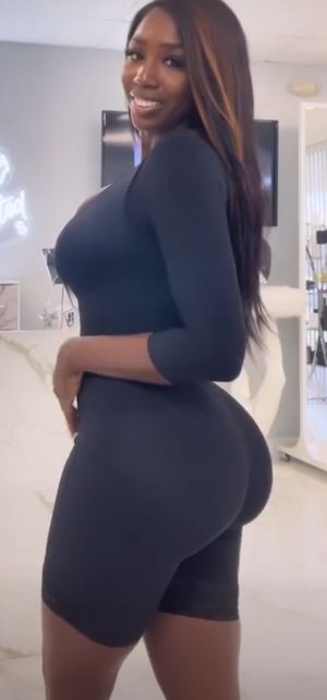 Ellie Mae black body stocking side view ass & boobs