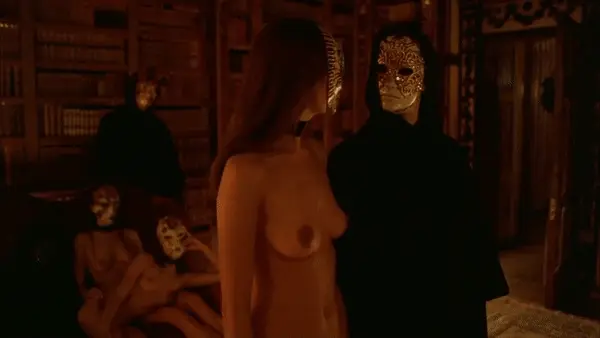 Sensuous lady entering the room to reunite with her pleasure-seeking companion enjoying the company of other women - Eyes Wide Shut Orgy