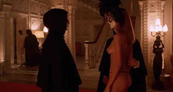 Gentleman takes a look at his companion's magnificient ass while she is escorted away by another man - Eyes Wide Shut Orgy