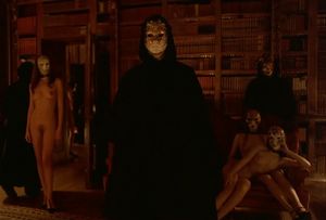 Beautiful brunette servant aproaches a man to make sure that he is well-entertained - Eyes Wide Shut Orgy