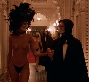 A hedonistic lady who cannot wait to enter the pleasure rooms taking a flirtous look at other excited couples - Eyes Wide Shut Orgy