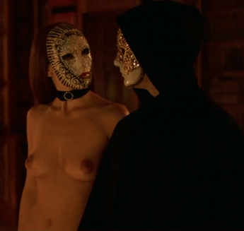 Brunette lady in a beautiful mask entertaining a gentleman with a coquettish conversation and a view of her naked body - Eyes Wide Shut Orgy