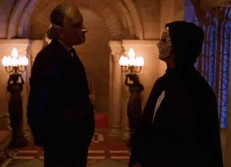 A joyful and carefree couple passing by while two masked gentleman are having a conversation
