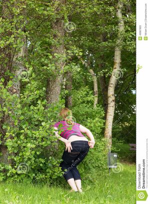 Woman about to pee outdoors