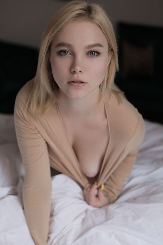Cute blonde shows us one puffy nipple