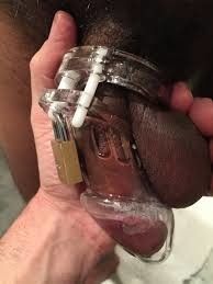 Black dick locked in a chastity cage
