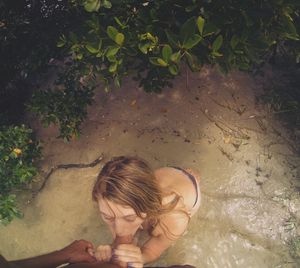 Brunette on her knees outdoors sucking on cock