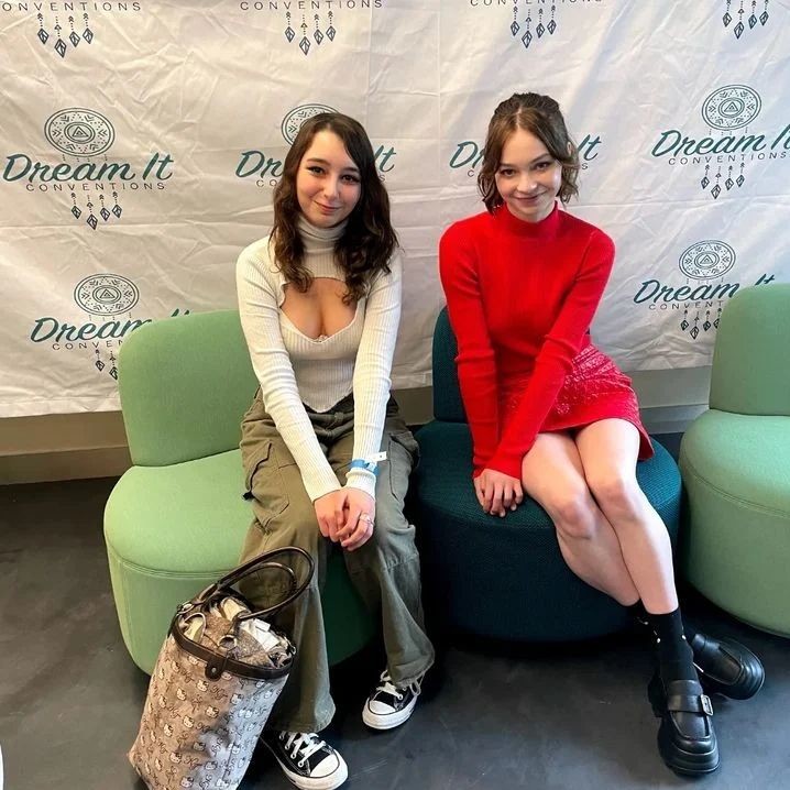 Emma with a fan showing legs