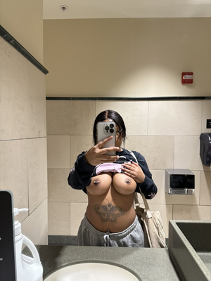 Flashing her pierced boobs in the bathroom