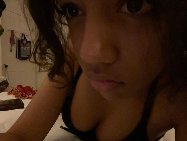 Stunning black cutie showing off her cleavage