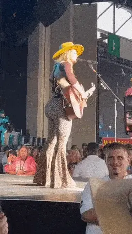 Lainey Wilson on stage with her big booty #10