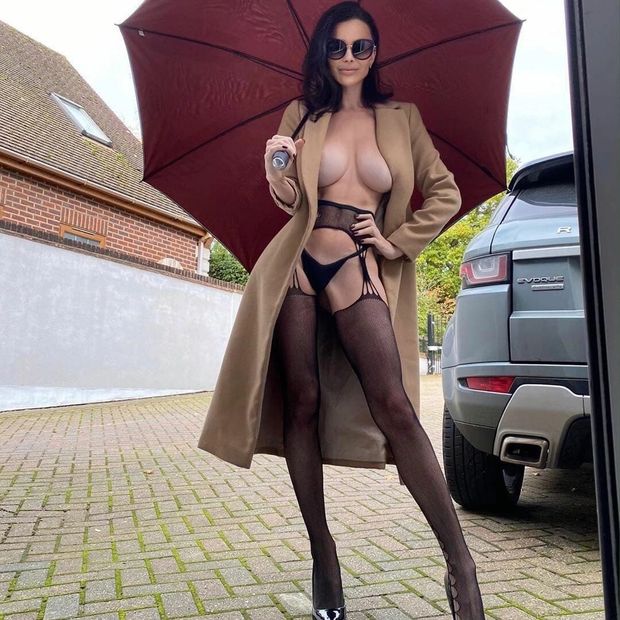 God sexy mommy standing outside with an umbrella