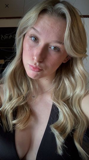 Abby curled hair black top cleavage