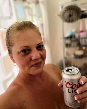 Juliana washing down some dog cum with a beer!