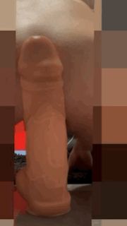 Sliding on huge dildo