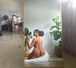 Taking a selfie of her butt and her tattoos