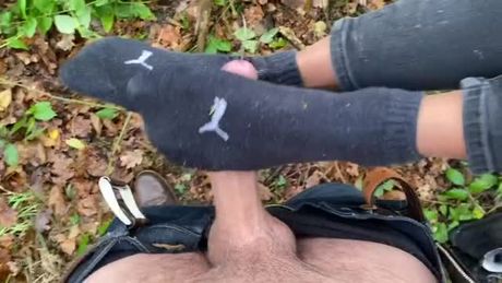 Footjob with socks in the wood
