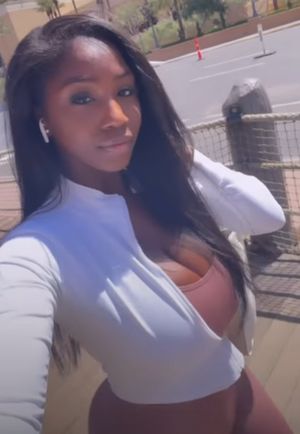 Ellie Mae selfie white top brown body suit