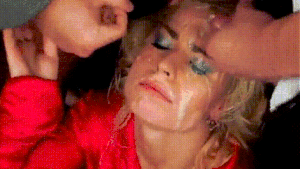 getting her face cummed on by two cocks