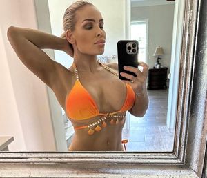 Natalya taking a Selfie in her Orange bikini