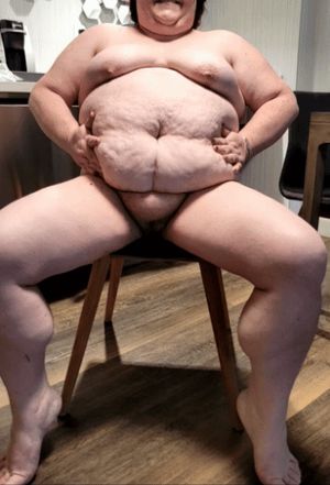 BBW squeezes her big beautiful belly under the spotlight