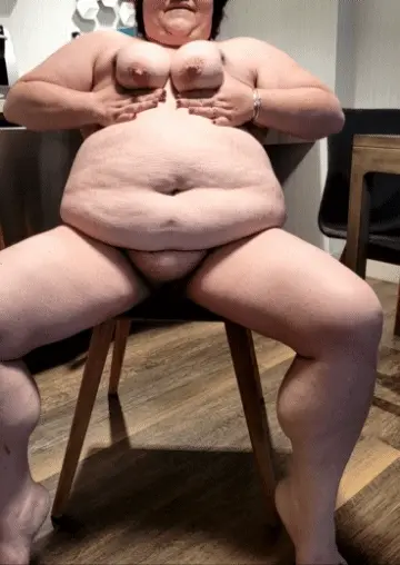 BBW sitting naked in spotlight playing with her tits