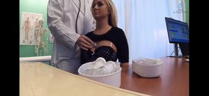 Doctor listening to her heartbeat with a stethoscope while her shirt is lifted up.