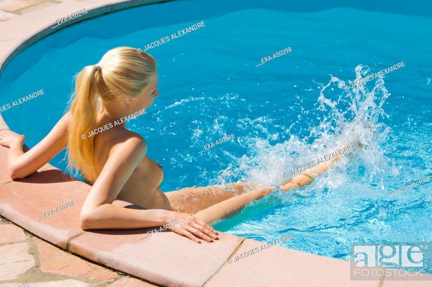 Naked blonde in a swimming pool