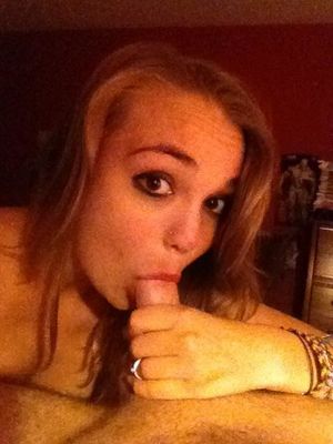 Doe-eyed amateur redhead sucking on an average-sized cock