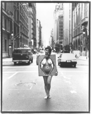 Annie Sprinkle - standing in the middle of the street in the nude.