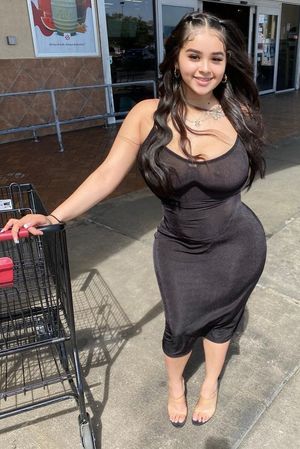 Val black see-through dress outside grocery store