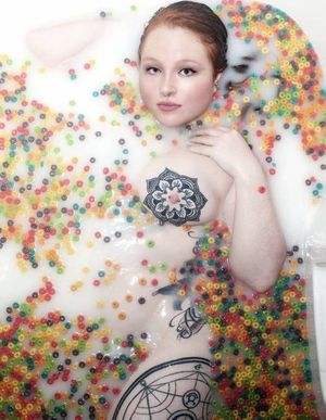 Some redhead chick with tattoos laying in a milkbath full of Froot-Loops. Don't ask me why ... I just post this stuff ...