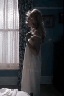 slowly slides down her nightgown
