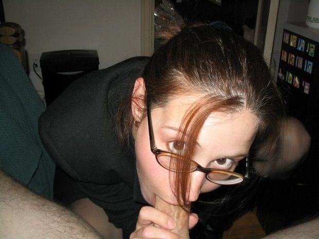 Clothed amateur brunette sucking on a dick