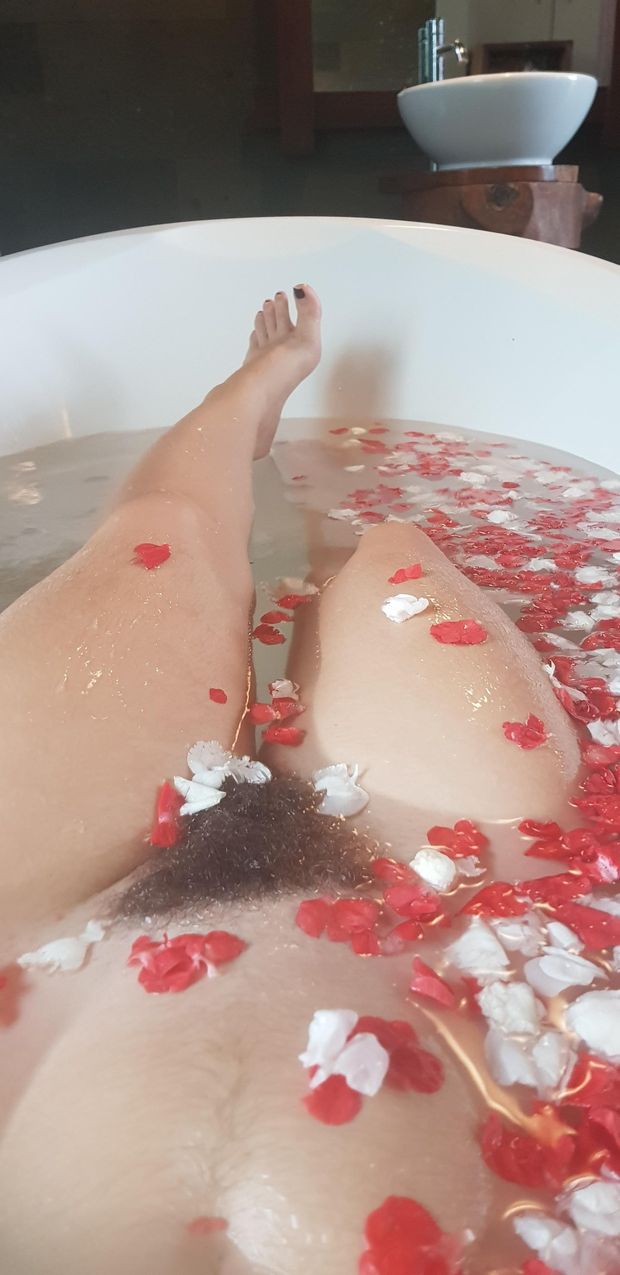 Wet Bush in the Tub Surrounded by Flower Petals