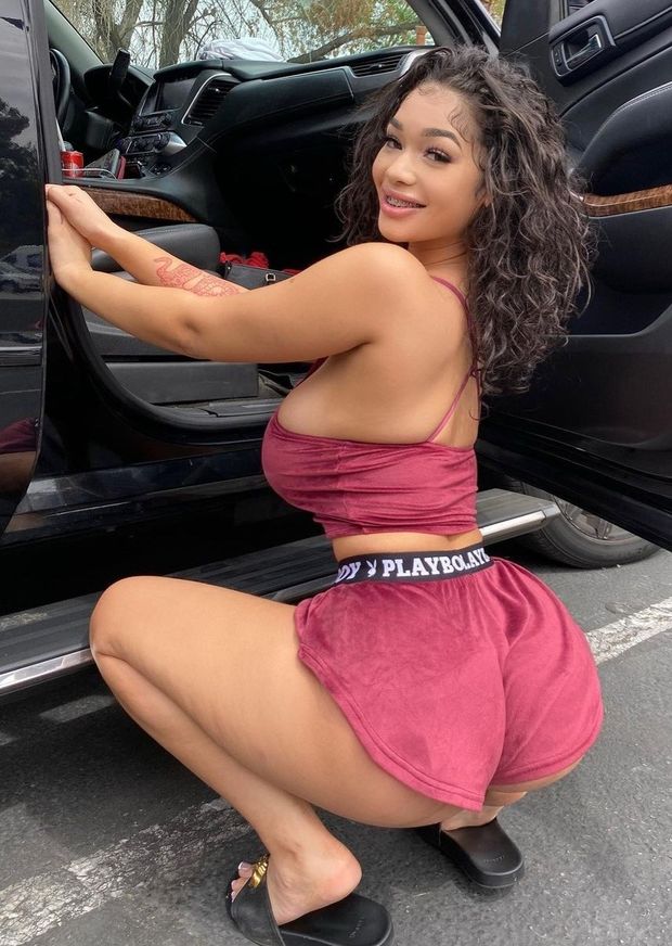 Lexie pink felt squatting in front of car