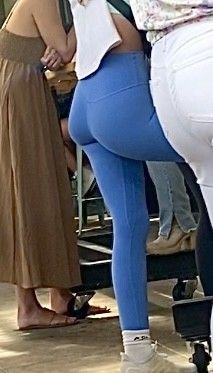 Hotty In blue leggings standing by the bar