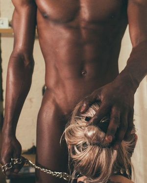 Chained babe sucks dick.