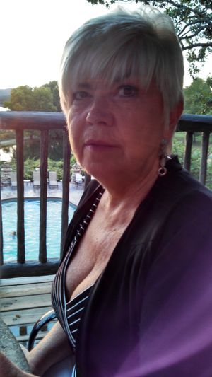 Sandy Ward drawing attention to her cleavage at public dinner.