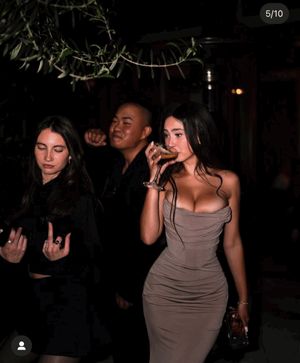 Bombshell brunette busting out of her dress