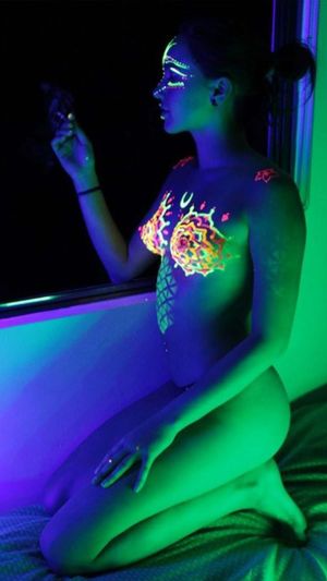 Fluoro Body Painted Beauty Having a Smoke
