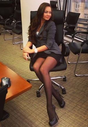 Sexy coworker in jacket and tight miniskirt