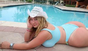 Jolie blue bikini laying at pool