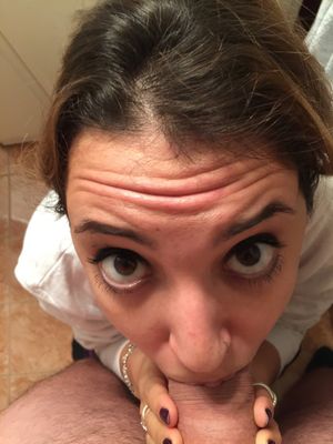 Close-up of a brunette amateur with doe-eyes shoving dick in her mouth