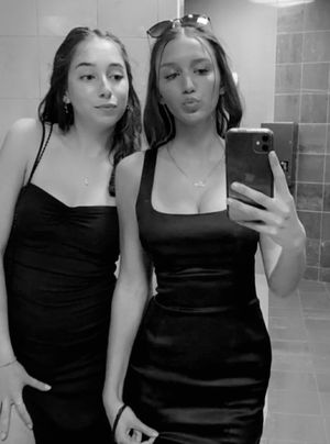 Alexa & friend bathroom selfie black dress