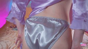 Vana pulling up her PJs over her shiny satin panties