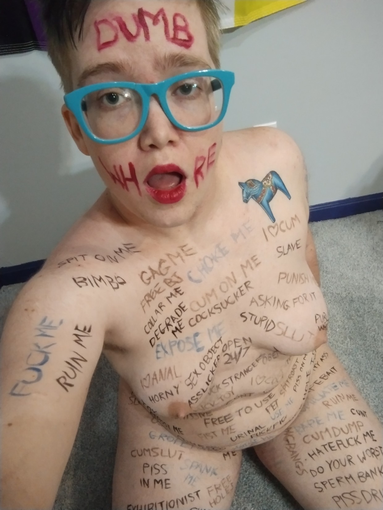 a dumb whore covered in bodywriting for the amusement of strangers