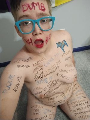 a dumb whore covered in bodywriting for the amusement of strangers