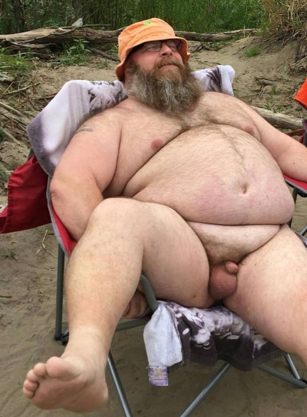 Chubby bearded man sitting with dick and balls out